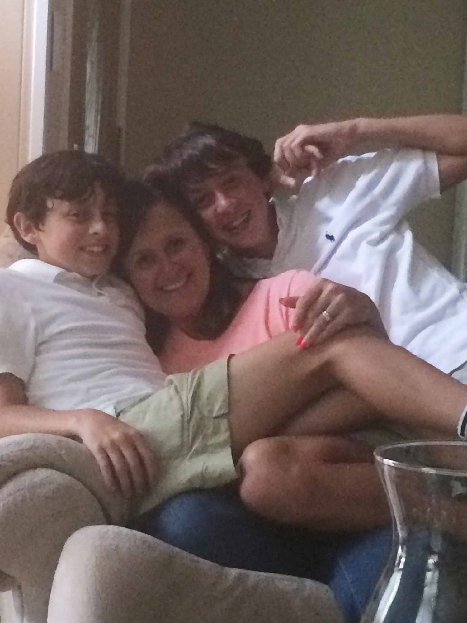 Zach with mother and brother on chair